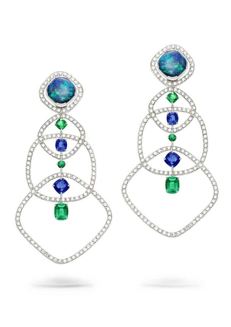 Mix and match your earrings with the opal-dial cuff watch in these Extremely Piaget earrings in white gold set with two cushion-cut black opals, brilliant-cut diamonds, blue sapphires and emeralds.