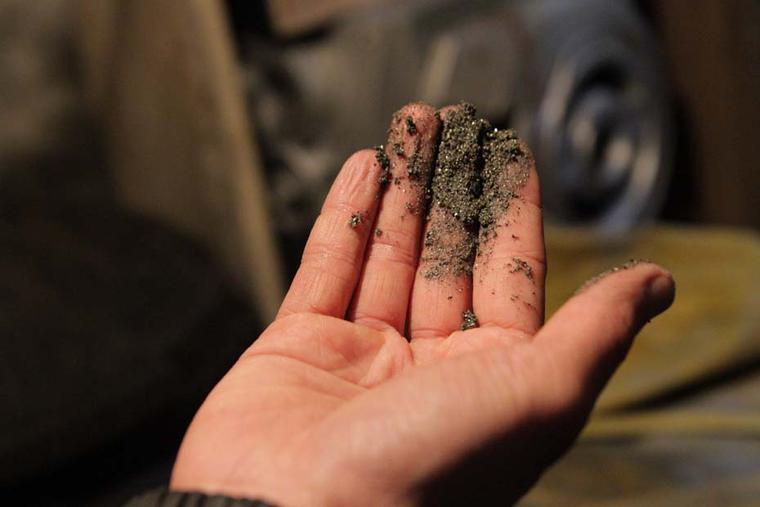 Miners unearth gold particles in the mines of Narino, Colombia, which have been certified as Fairmined