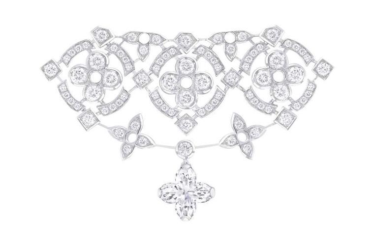 LOT:348, LOUIS VUITTON - a diamond 'LV' pendant.